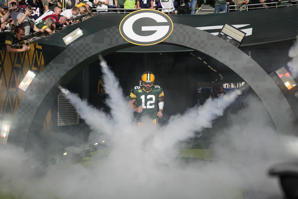 Green Bay Packers quarterback Aaron Rodgers (12) enters the field at the start of an NFL game between the New York Giants and the Green Bay Packers at the Tottenham Hotspur stadium in London, Sunday, Oct. 9, 2022. (AP Photo/Alastair Grant)