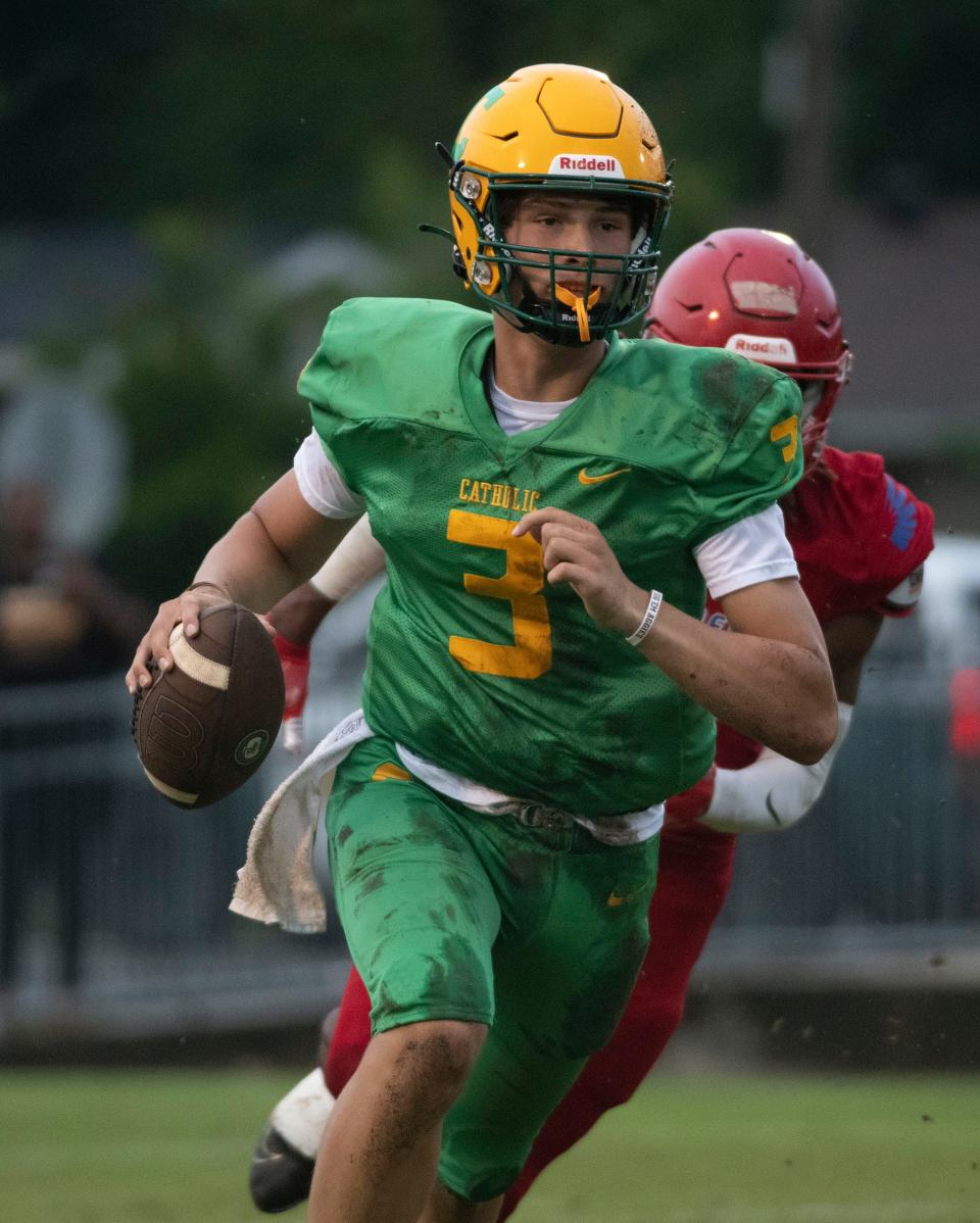 Catholic's quarterback Ryan Huff (No. 3) rolls out of the pocket as the Pine Forest defense brings the pressure during Wednesday's Spring football game. 