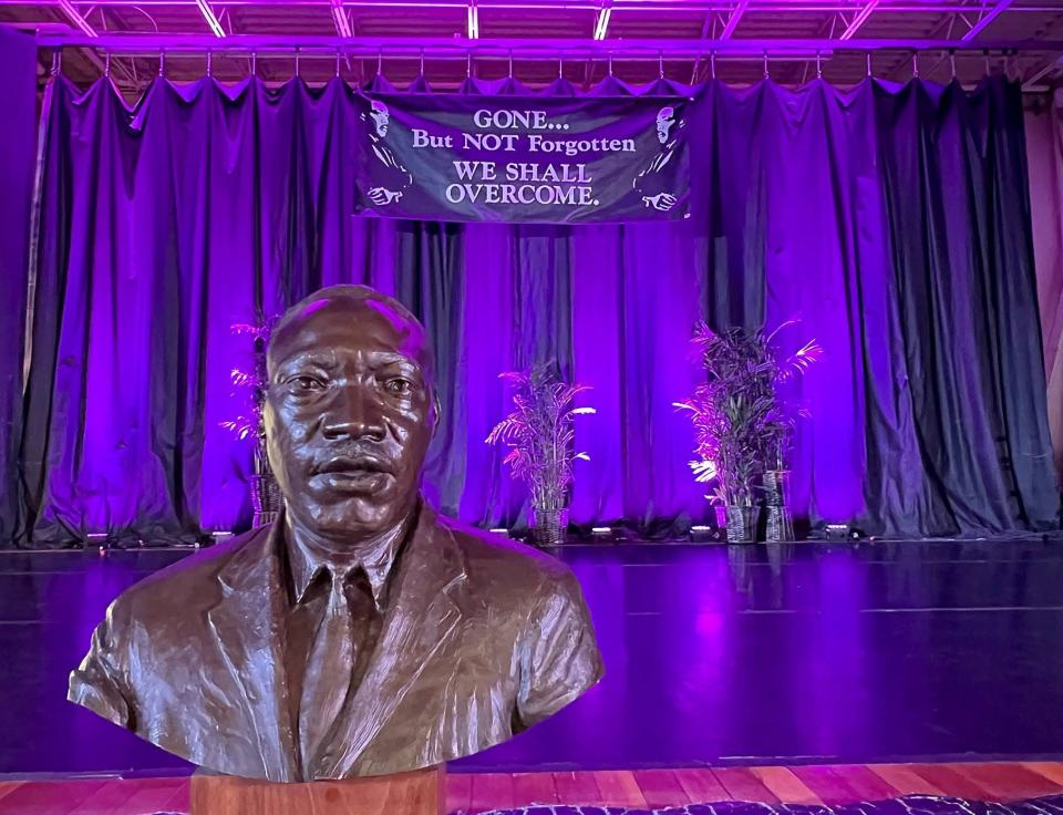 A statuette of Martin Luther King Jr. sat in front of the Martin Luther King Center stage where a memorial service was held following the march in Erie on Monday afternoon.