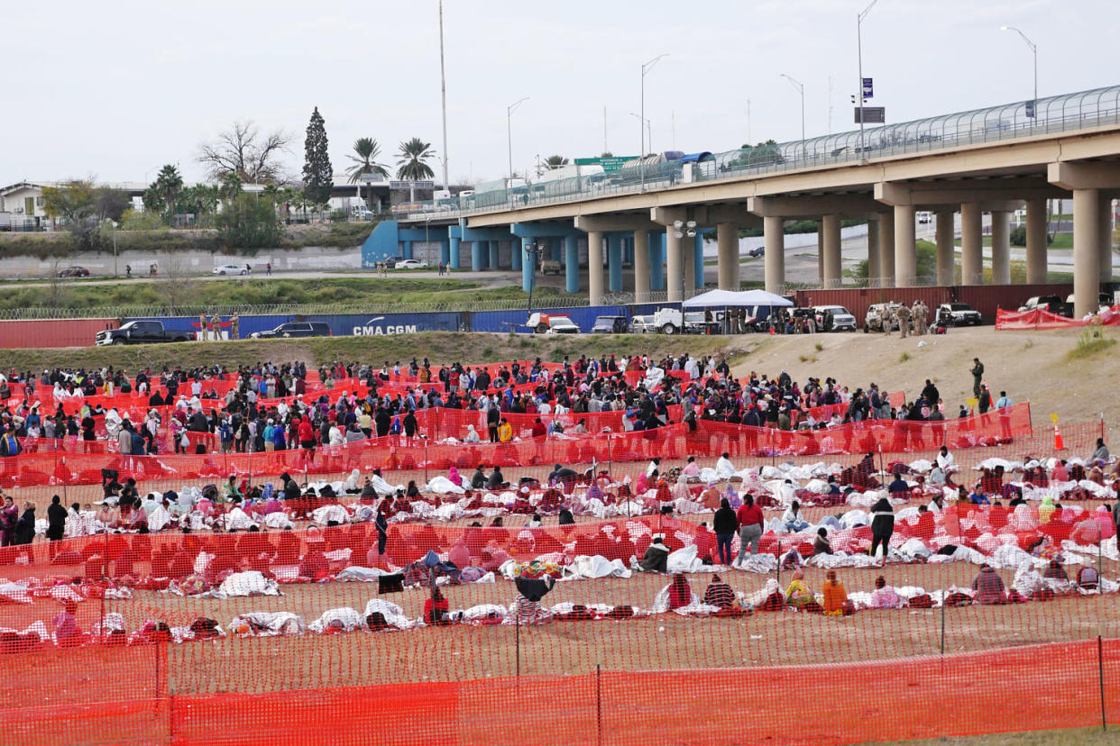 Immigrants wait to be processed at a U.S. Border Patrol transit center after they crossed the border from Mexico in Eagle Pass, Texas, on Dec. 20, 2023. (Francois Picard / AFP - Getty Images)