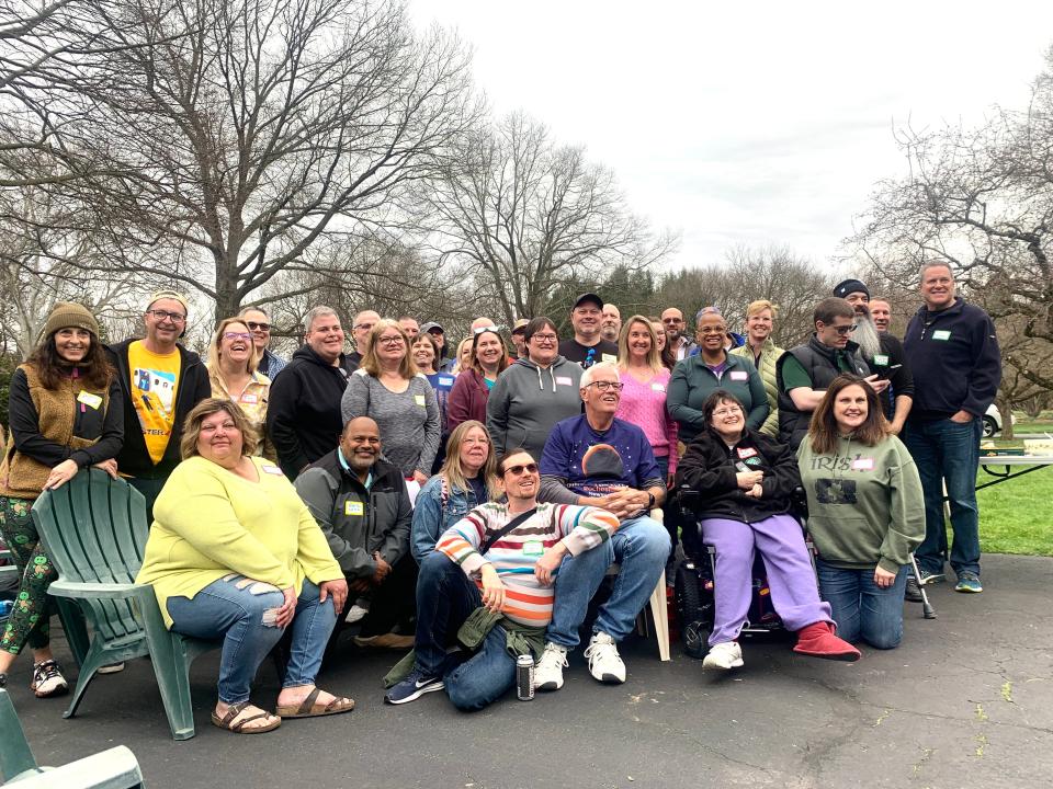 Patrick Moriarty, center, takes a group photo with former students who gathered at his home for the eclipse on April 8, 2024.