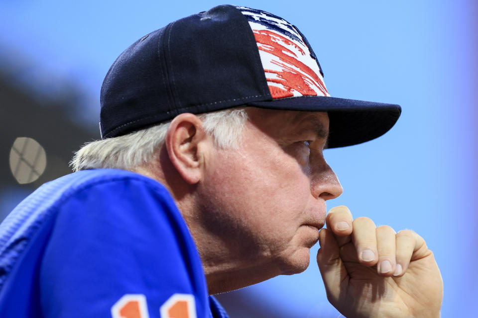 New York Mets' Buck Showalter watches his team from the dugout steps during the seventh inning of a baseball game against the Cincinnati Reds in Cincinnati, Monday, July 4, 2022. (AP Photo/Aaron Doster)