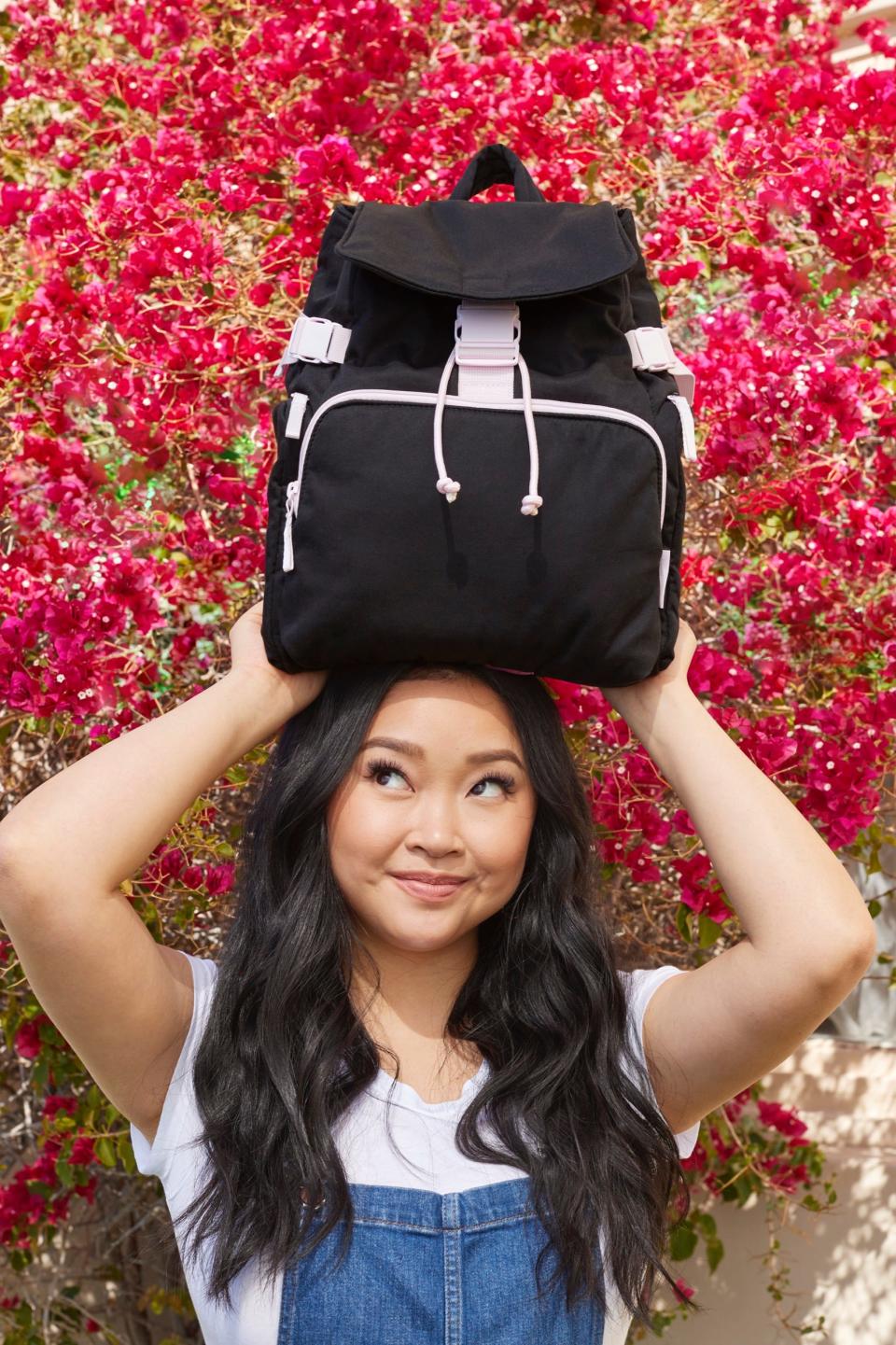 Lana Condor posing with the Lana Utility Backpack that she designed as part of her collaboration with Vera Bradley.