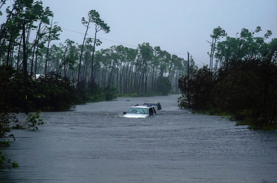 Cars sit submerged in water from Hurricane Dorian in Freeport, Bahamas, Tuesday, Sept. 3, 2019. Dorian is beginning to inch northwestward after being stationary over the Bahamas, where its relentless winds have caused catastrophic damage and flooding.(AP Photo/Ramon Espinosa)