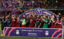 Soccer Football - Leicester City v Liverpool - Pre Season Friendly - The Premier League Asia Trophy - Final - June 22, 2017 Liverpool's Jordan Henderson celebrates winning by lifting the trophy alongside team mates REUTERS/BOBBY YIP