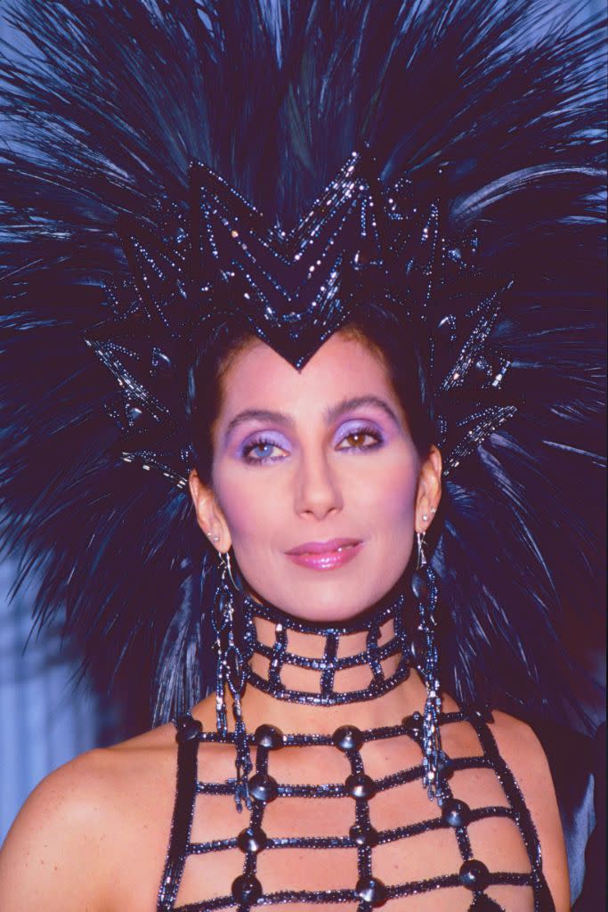 Cher in a Bob Mackie gown and headdress at the 1986 Oscars. The singer and actress has been called the “Queen of Camp” for her dramatic costumes and fashion risk taking. - Credit: Shutterstock