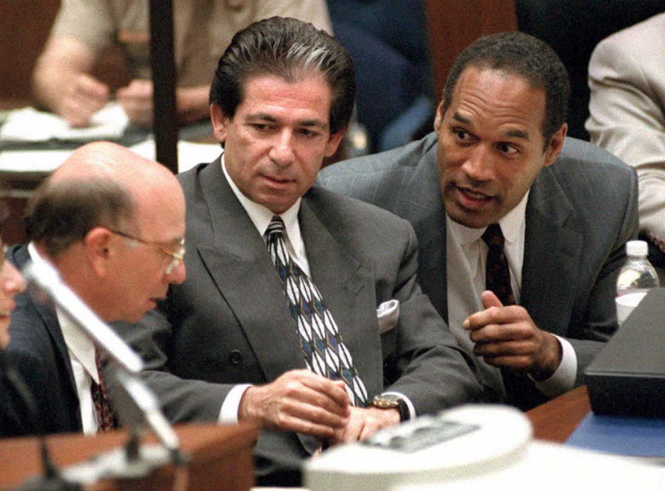 LOS ANGELES, UNITED STATES:  Murder defendant O.J. Simpson (R) consults with friend Robert Kardashian (C) and Alvin Michelson (L), the attorney representing Kardashian, during a hearing about Kardashian taking the witness stand in the O.J. Simpson murder case 03 May in Los Angeles. The prosecution wants to call Kardashian to the witness stand to question him on missing bags that O.J. Simpson took on his flight to Chicago on the night of the murders.  AFP PHOTO (Photo credit should read Vince Bucci/AFP via Getty Images)