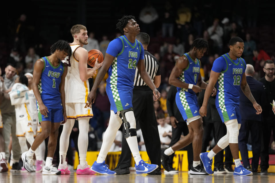 Florida Gulf Coast forward Josiah Shackleford (24) walks off the court with teammates after the 77-57 loss to Minnesota of an NCAA college basketball game Saturday, Dec. 9, 2023, in Minneapolis. (AP Photo/Abbie Parr)