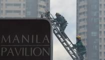 Clouds of smoke covered several floors of the building and swathed ladders of firefighters