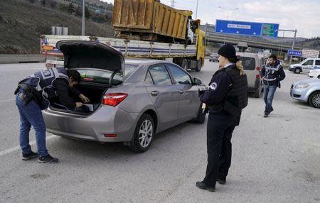 A police officer searches a car during a security control check in Ankara, Turkey March 17, 2016. REUTERS/Umit Bektas