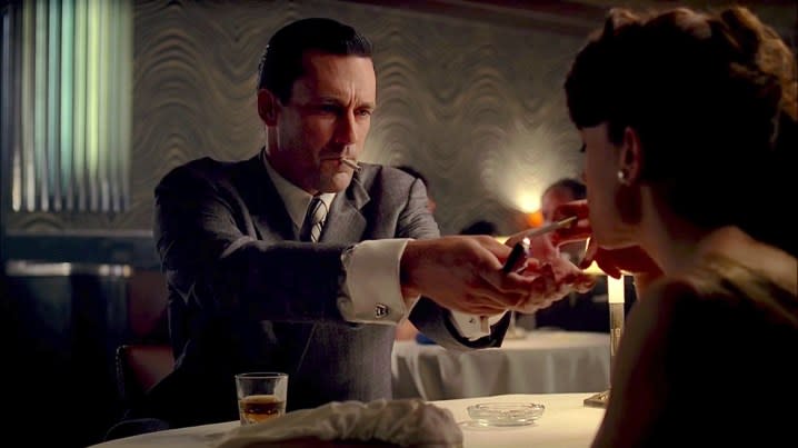 A man lights a woman's cigarette in Mad Men's pilot.