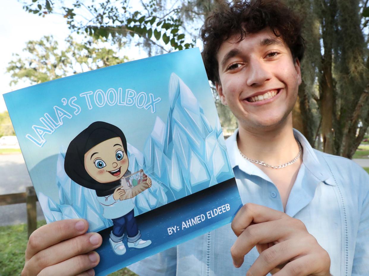 Ahmed Eldeeb, a 17-year-old activist, author and climate researcher, and his book "Laila's Toolbox," Tuesday, Oct. 3, 2023, in Ormond Beach.