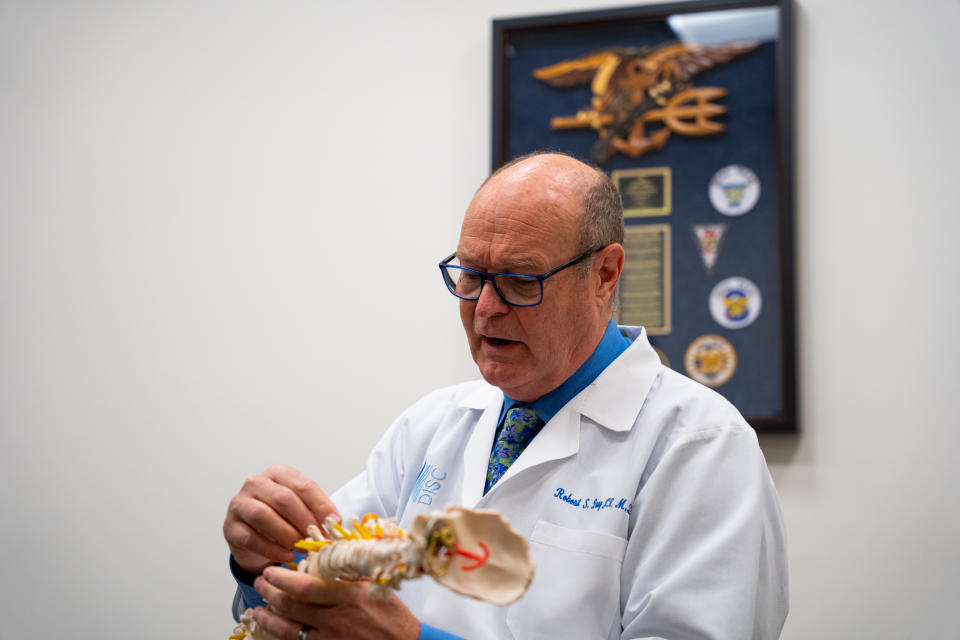 This 2022 photo provided by DISC Sports & Spine Center shows Dr. Robert S. Bray Jr. explaining minimally invasive spine surgery at the DISC Surgery Center in Newport Beach, Calif. Bray has performed countless disk surgeries. He has helped extreme sports standouts like big wave surfer Koa Rothman, actor Melissa Gilbert and Chicago Blackhawks center Tyler Johnson, who followed the lead of Vegas Golden Knights' Jack Eichel after years and years of chronic numbness and pain. (Matt Goulding/DISC Sports & Spine Center via AP)