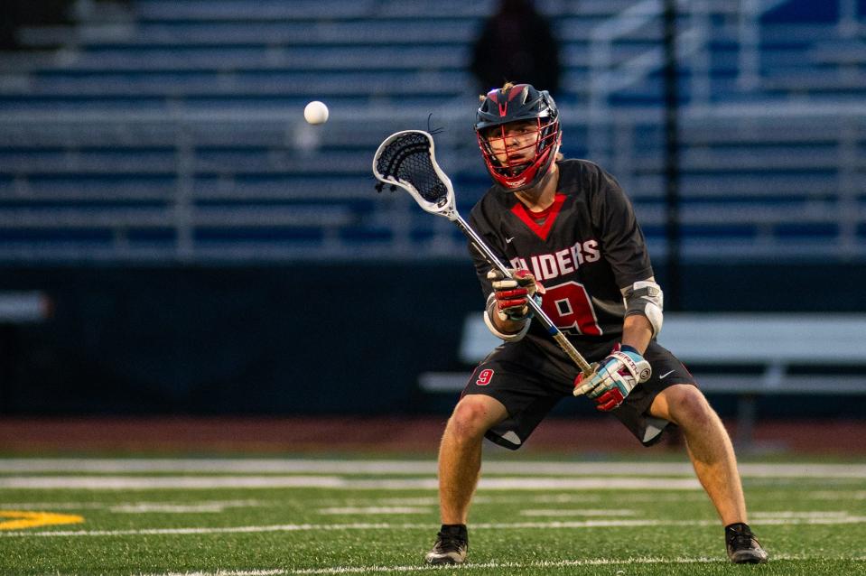 Red Hook's Nate Strassberger receives a pass during an April 19, 2024 boys lacrosse game against Lourdes.