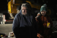 Farmers spend the night at a highway barricade in Aix-en-Provence, southern France, Tuesday, Jan. 30, 2024. France's protesting farmers encircled Paris with traffic-snarling barricades Monday, using hundreds of lumbering tractors and mounds of hay bales to block highways leading to France's capital to pressure the government over the future of their industry. (AP Photo/Daniel Cole)