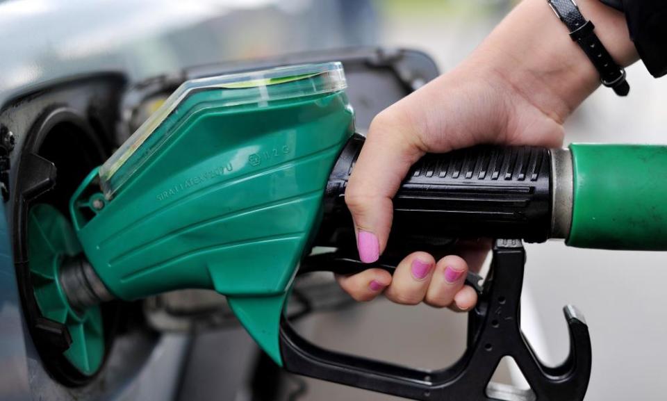 A person using a petrol pump