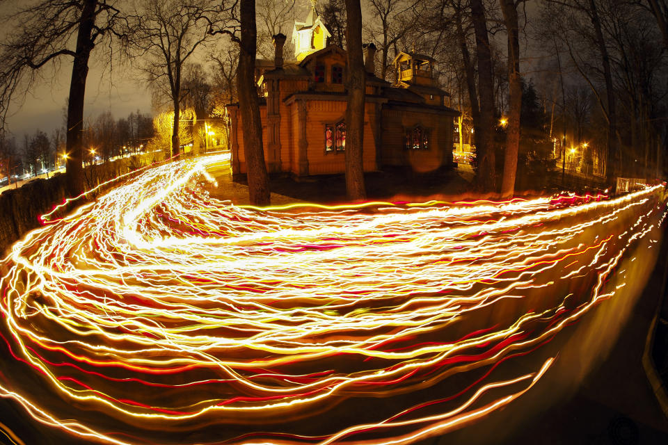 In this time exposure photo, Orthodox worshippers trail candle lights around a church during Orthodox Easter midnight mass in St. Petersburg, Russia, Sunday, April 16, 2023. Eastern Orthodox churches observe the ancient Julian calendar, and this year celebrate the Orthodox Easter on April 16. (AP Photo/Dmitri Lovetsky)