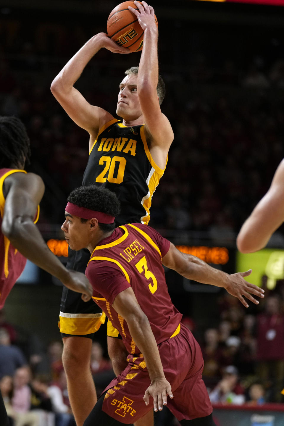 Iowa forward Payton Sandfort (20) is fouled by Iowa State guard Tamin Lipsey (3) during the first half of an NCAA college basketball game, Thursday, Dec. 7, 2023, in Ames, Iowa. (AP Photo/Charlie Neibergall)