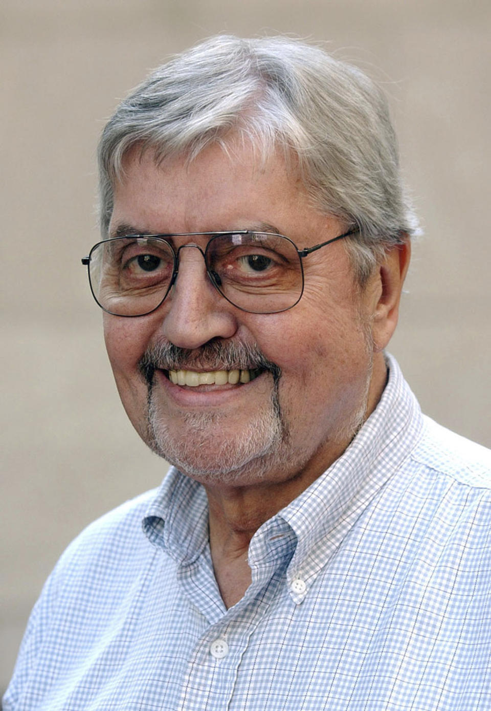 FILE - In this Aug. 9, 2002, photo, Richard Pyle smiles at Rockefeller Center in New York. Longtime Associated Press journalist Pyle has been laid to rest at Arlington National Cemetery nearly one year after his death. Dozens of Pyle’s relatives, friends and former colleagues gathered Monday, Aug. 20, 2018, for a ceremony at the Virginia cemetery, where his ashes were placed in a memorial wall. (AP Photo/Mark Lennihan, File)