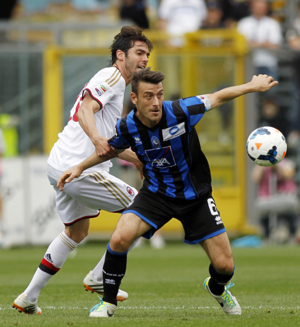 AC Milan Brazilian midfielder Kaka', left, and Atalanta's Giampaolo Bellini fight for the ball during a Serie A soccer match in Bergamo, Italy, Sunday, May 11, 2014. (AP Photo/Felice Calabro')