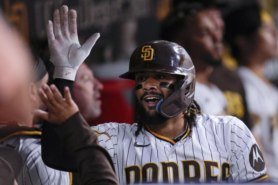 San Diego Padres' Fernando Tatis Jr. celebrates with teammates in the dugout after stealing home during the seventh inning of a baseball game against the Baltimore Orioles, Wednesday, Aug. 16, 2023, in San Diego. (AP Photo/Gregory Bull)