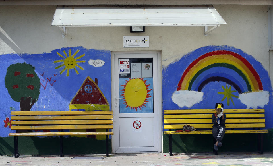 A migrant child plays with a doll in a center for asylum-seekers in the northern Serbian city of Subotica, Wednesday, May 8, 2019. Hungary, which greatly tightened asylum procedures last year, rejected the families' asylum requests and gave them the choice of being expelled to Serbia or being flown back to Afghanistan. (AP Photo/Darko Vojinovic)