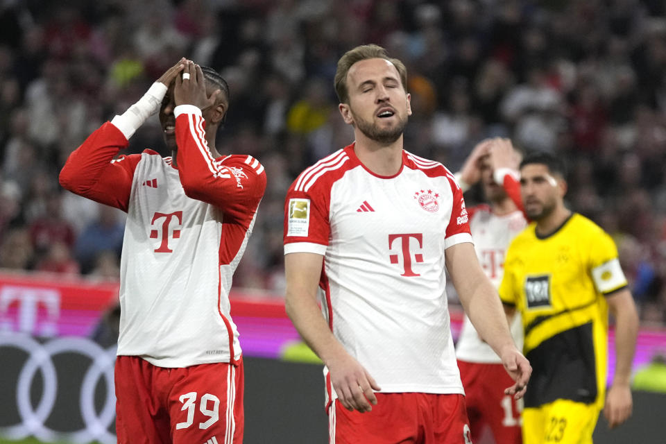 Bayern's Mathys Tel, left, and Bayern's Harry Kane react during the German Bundesliga soccer match between FC Bayern Munich and Borussia Dortmund at the Allianz Arena stadium, in Munich, Germany, Saturday, March 30, 2024. (AP Photo/Matthias Schrader)