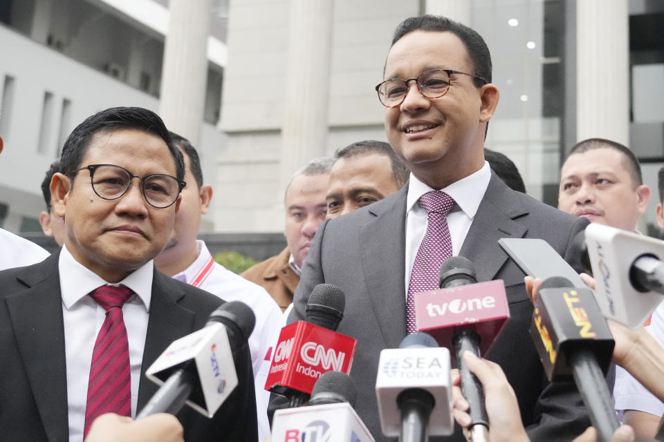 Losing presidential candidate Anies Baswedan, right, talks to journalists as his running mate Muhaimin Iskandar listens upon their arrival for hearing appeals against the presidential election results, which were lodged by losing candidates, at the Constitutional Court in Jakarta, Indonesia, Wednesday, March 27, 2024. (AP Photo/Achmad Ibrahim)