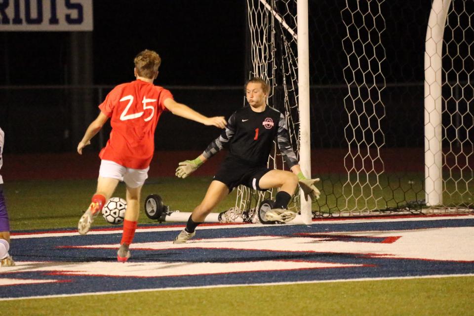 Oakland goalkeeper Will Palmer prepares to stop a shot attempt by Smyrna as teammate Hayden Rogers (25) helps on defense during Tuesday's Region 4-AAA semifinals.