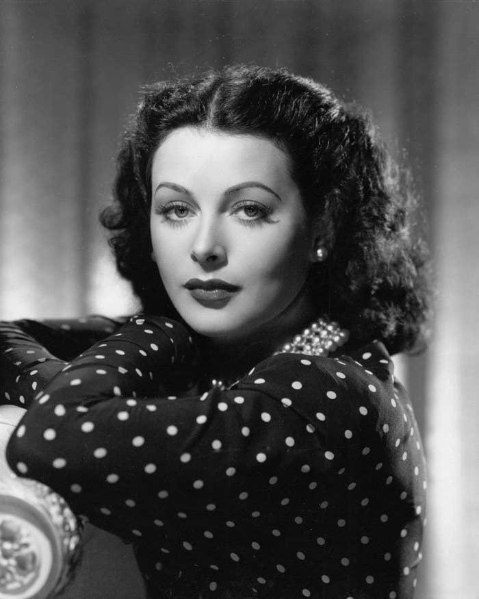 Hedy Lamarr wearing a polka dot blouse while having her portrait taken