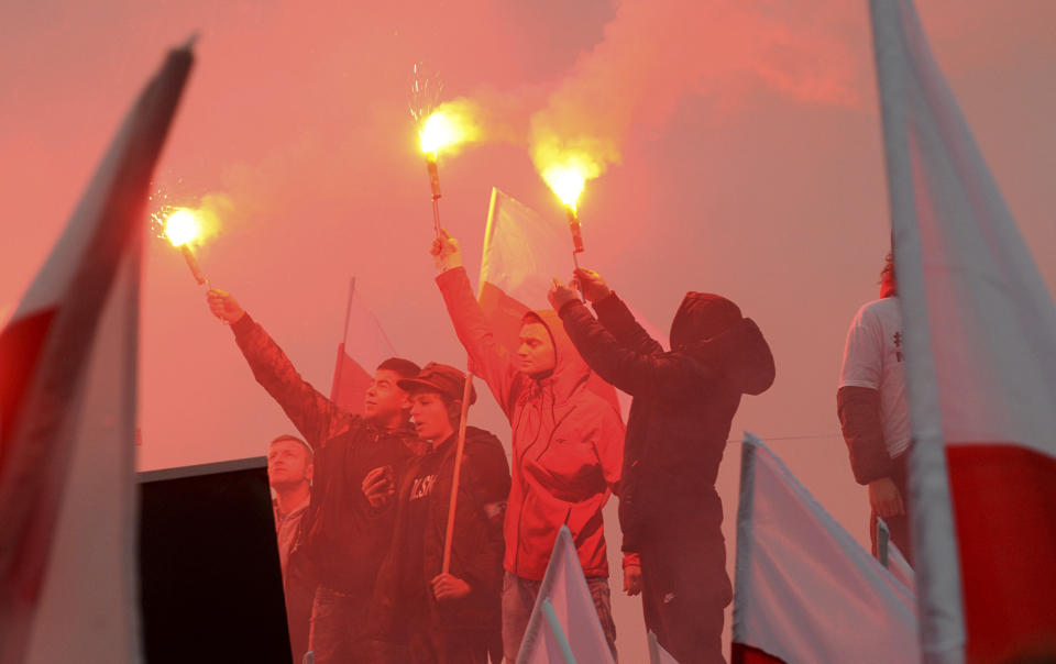 Marchers burn flares in the annual March of Independence organized by far right activists to celebrate 100 years of Poland's independence. The nation of Poland regained its sovereignty at the end of World War I after being wiped off the map for more than a century. (AP Photo/Alik Keplicz)