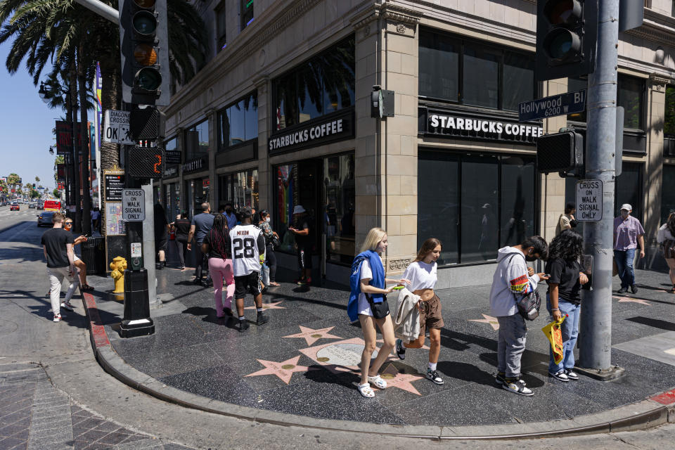 Los Angeles, CA - July 13: Pedestrians walk by the Starbucks on Hollywood Blvd. and Vine St., on Wednesday, July 13, 2022 in Los Angeles, CA. (Wesley Lapointe / Los Angeles Times via Getty Images)