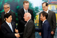 Trade ministers pose for a group photo during the APEC Ministers Responsible For Trade (APEC MRT 23) meeting in Hanoi, Vietnam May 20, 2017. From L-R, front: China's Commerce Minister Zhong Shan, Peru's Foreign Commerce and Tourism Minister Eduardo Ferreyros and Vietnam's Trade and Industry Minister Tran Tuan Anh. From L-R, back: Philippines' Trade Secretary Ramon Lopez, U.S. Trade Representative Robert Lighthizer and Singapore's Trade Minister Lim Hng Kiang. REUTERS/Kham