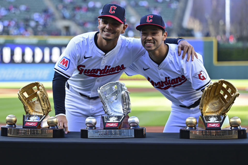 Cleveland Guardians second baseman Andres Gimenez, left, and left fielder Steven Kwan pose with their 2023 Gold Glove and Platinum Glove awards, before the second baseball game of the team's doubleheader against the New York Yankees on Saturday, April 13, 2024, in Cleveland. (AP Photo/David Dermer)