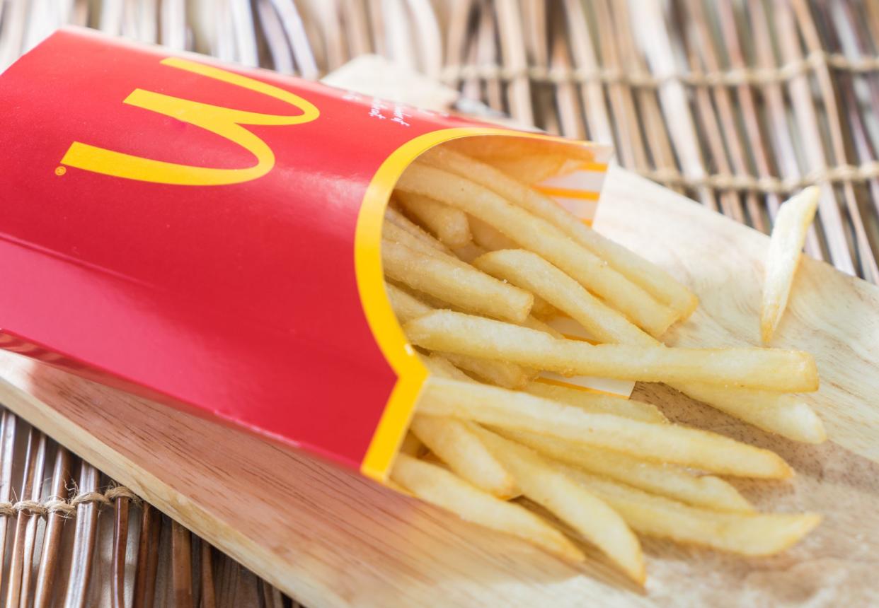 Bangkok, Thailand - September 19, 2015: A box of Mc Donalds French Fries on a wooden tray.