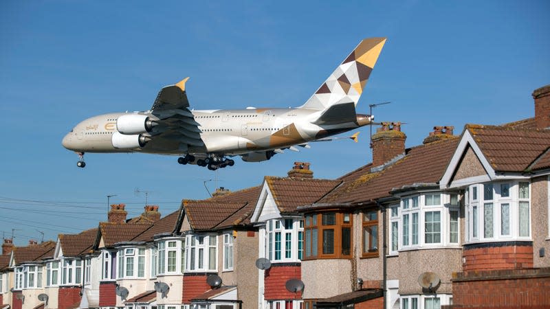 An Etihad A380 approaching Heathrow Airport over homes to land.