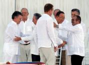 (From left) Colombia's President Juan Manuel Santos and Cuba's President Raul Castro shake hands as United Nations Secretary-General Ban Ki-moon (2nd R) and Marxist rebel leader Rodrigo Londono (R), better known by the nom de guerre Timochenko, shake hands as well, next to Norway's Foreign Minister Boerge Brende in Cartagena, Colombia September 26, 2016. REUTERS/John Vizcaino/File Photo