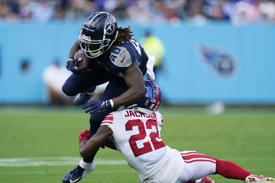 Tennessee Titans running back Dontrell Hilliard (40) catches a pass as he is tackled by New York Giants cornerback Adoree' Jackson (22) during the first half of an NFL football game Sunday, Sept. 11, 2022, in Nashville. (AP Photo/Mark Humphrey)