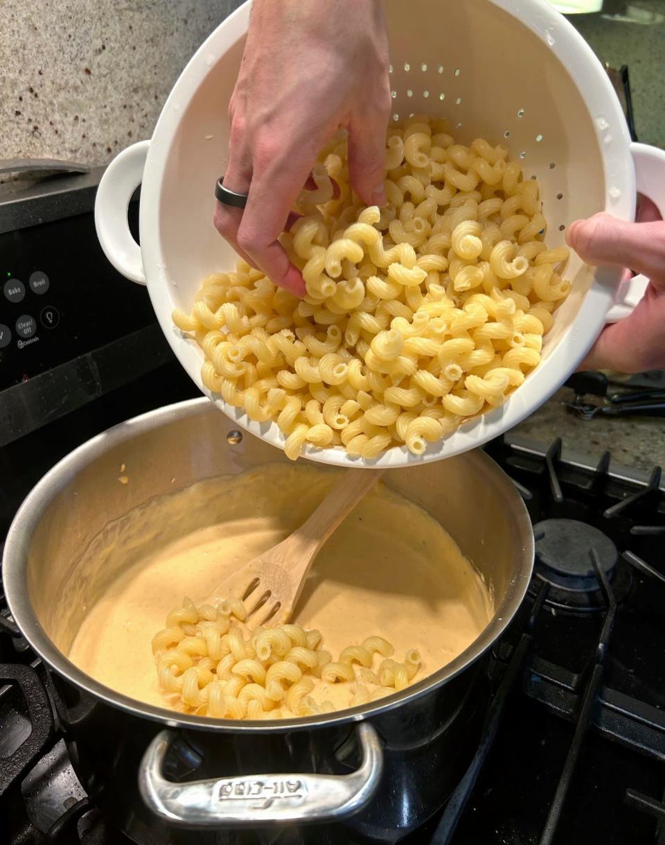 Adding pasta to cheese sauce for Tini's mac and cheese