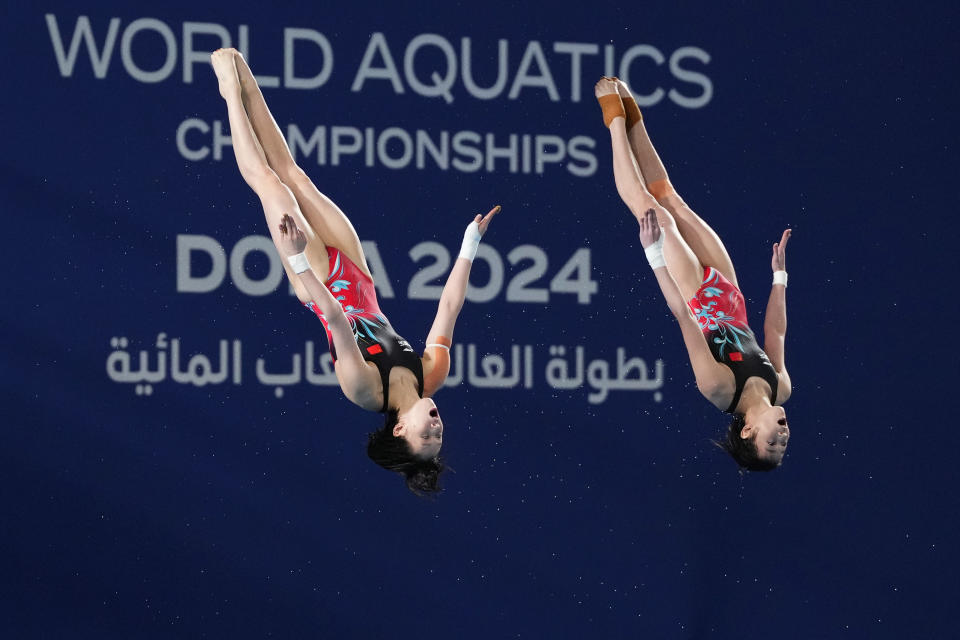 Chen Yuxi and Quan Hongchan of China compete during the women's synchronized 10m platform diving final at the World Aquatics Championships in Doha, Qatar, Tuesday, Feb. 6, 2024. (AP Photo/Hassan Ammar)