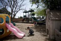 In this April 14, 2014 photo, a 3-year-old boy plays in the playground at Community Day Preschool of Garden Grove in Garden Grove, Calif. According to the school's executive director Sue Puisis, the enrollment at the preschool has dropped by more than 50 percent since 2008. The financial crisis that followed the collapse of U.S. investment bank Lehman Brothers in 2008 sent birth rates tumbling around the world as couples found themselves too short of money or too fearful about their finances to have children. Six years later, birth rates haven't bounced back. (AP Photo/Jae C. Hong)