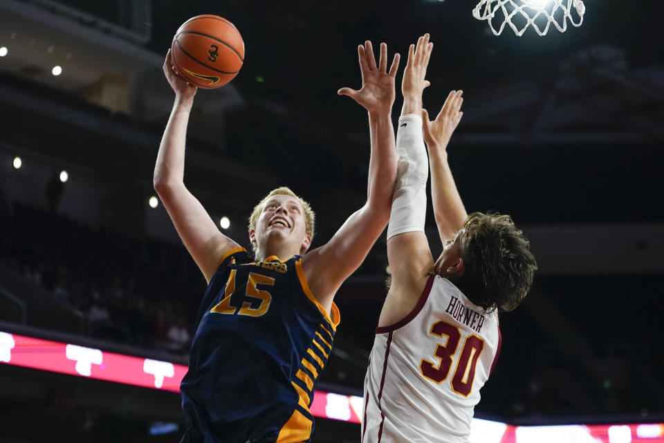 UC Irvine center Bent Leuchten, left, shoots against Southern California forward Harrison Hornery during the second half of an NCAA college basketball game Tuesday, Nov. 14, 2023, in Los Angeles. (AP Photo/Ryan Sun)