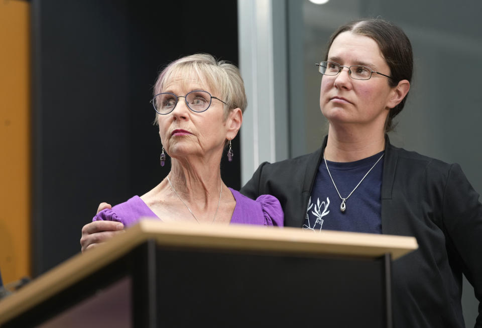 Kathleen Boleyn, left, mother of man who was fatally shot by a police officer from the Arvada, Colo., Police Department in June 2021, is hugged by her daughter, Erin Hurley, during a news conference to talk about the $2.8-million settlement reached with the northwest Denver suburban city Thursday, Sept. 28, 2023, in Denver. Boleyn's son, Johnny Hurley, was shot after he had killed an active shooter who had killed an Arvada officer in the city's Olde Town area on June 21, 2021. (AP Photo/David Zalubowski)