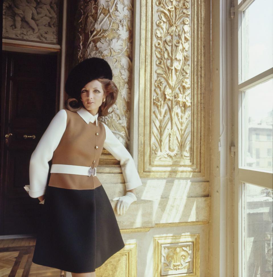 Mila Schön’s “tricolored belted coatdress for a great day in town—black and white with a mock weskit of tan, gold-and-enamel buttons, and buckle. Agnona wool. Buckle, buttons by Loris Abate. Mila Schön hat.”