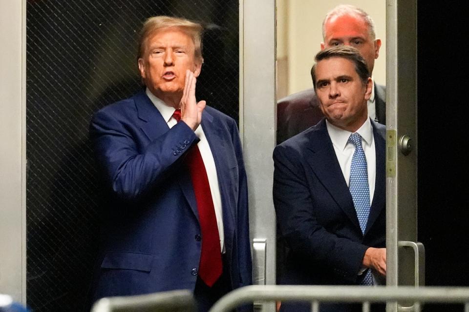 Former President Donald Trump comments as he leaves a pre-trial hearing during a recess with his lawyer Todd Blanche at court in New York on Monday (AP)