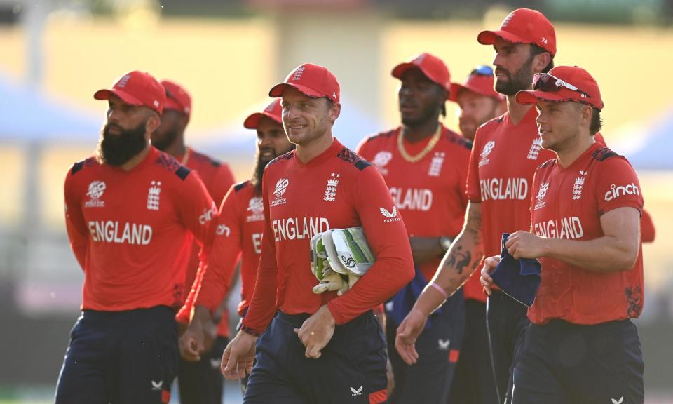 <span>Jos Buttler leads his team off the field after their victory over Namibia.</span><span>Photograph: Gareth Copley/Getty Images</span>