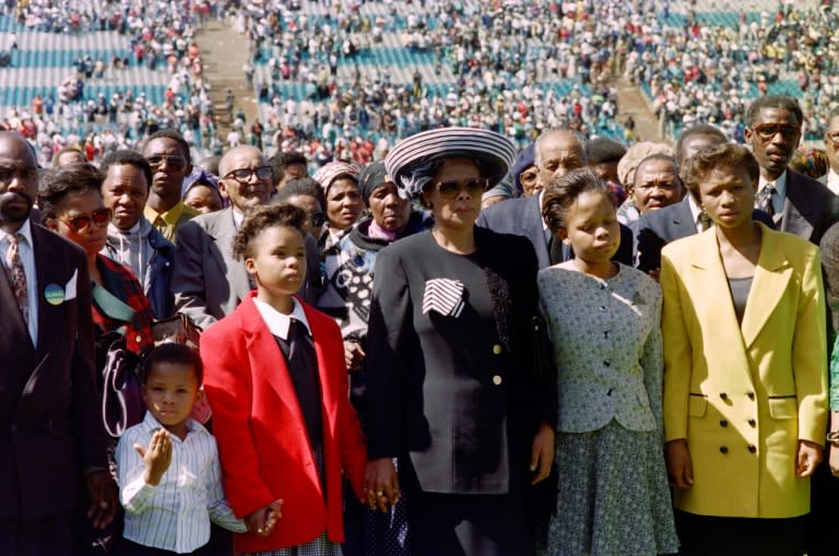 Chris Hani's wife Limpho stands with her children during a vigil for her husband in Soweto on April 18, 1993