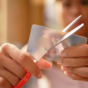 Woman cutting her credit card web