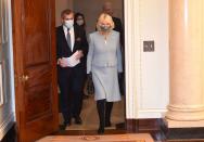<p>The Duchess of Cornwall wore a powder blue suit, knee high boots, and dragonfly pins to visit the headquarters of the Bank of England in London. She paired the look with a floral protective mask. </p>