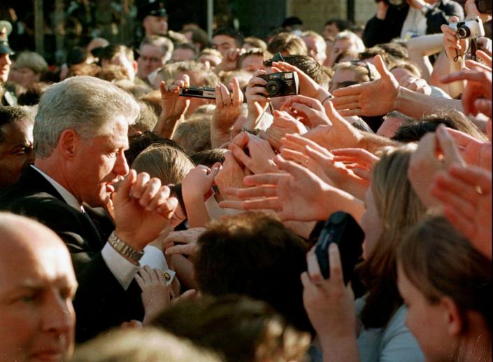 بیل کلینتون، رئیس جمهور ایالات متحده، در سفر خود به اوماغ، ایرلند شمالی، پنجشنبه 3 سپتامبر 1998، برای دست دادن مردم اوماغ دراز می کند. اوماغ صحنه انفجار بمبی بود که در 15 اوت 1998 28 نفر را کشت.